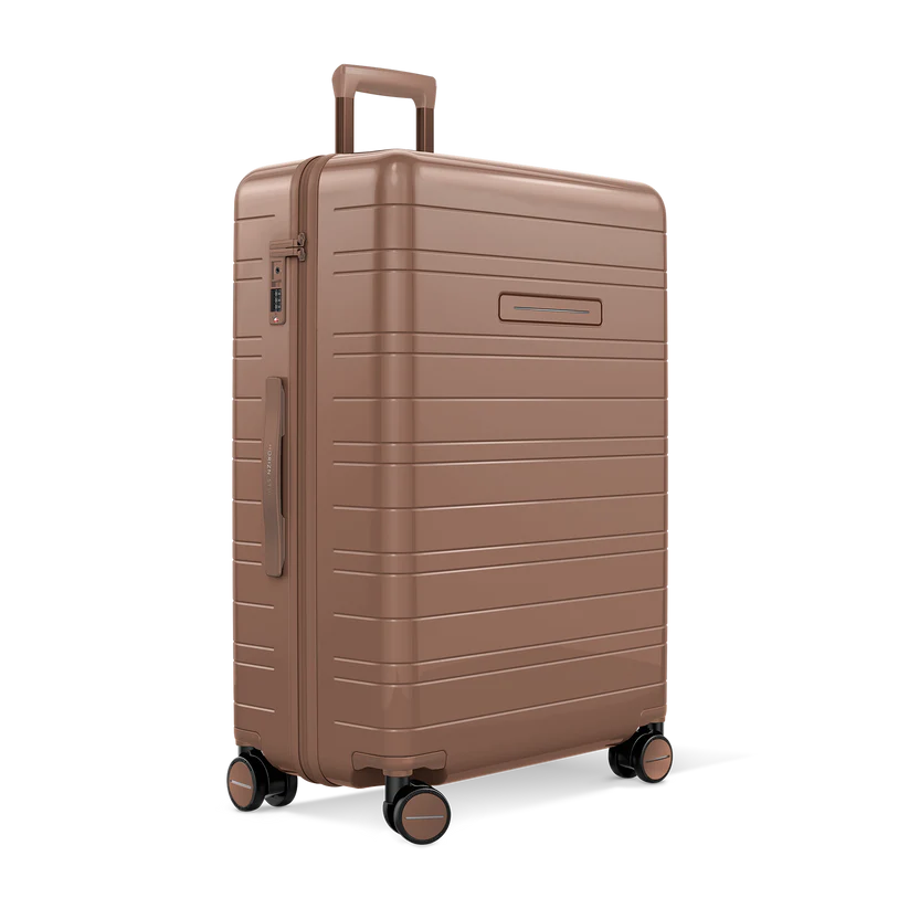 Horizn Studios H7 RE glossy mocha check-in suitcase with four wheels and sleek design, standing upright on a white background.